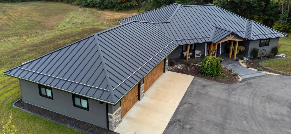 Modern ranch home with a charcoal standing seam metal roof and wood trim